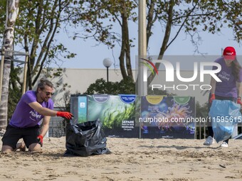 Several volunteers collect waste and garbage during a beach cleanup day in the municipality of Alges in Lisbon, Portugal, on September 21, 2...