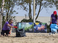 Several volunteers collect waste and garbage during a beach cleanup day in the municipality of Alges in Lisbon, Portugal, on September 21, 2...