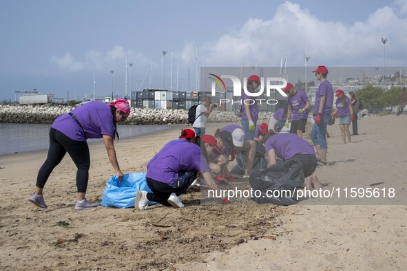 Several volunteers collect waste and garbage during a beach cleanup day in the municipality of Alges in Lisbon, Portugal, on September 21, 2...