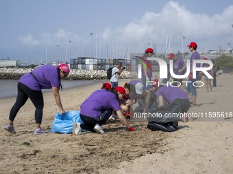 Several volunteers collect waste and garbage during a beach cleanup day in the municipality of Alges in Lisbon, Portugal, on September 21, 2...