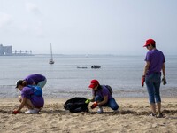 Several volunteers collect waste and garbage during a beach cleanup day in the municipality of Alges in Lisbon, Portugal, on September 21, 2...