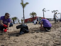 Several volunteers collect waste and garbage during a beach cleanup day in the municipality of Alges in Lisbon, Portugal, on September 21, 2...