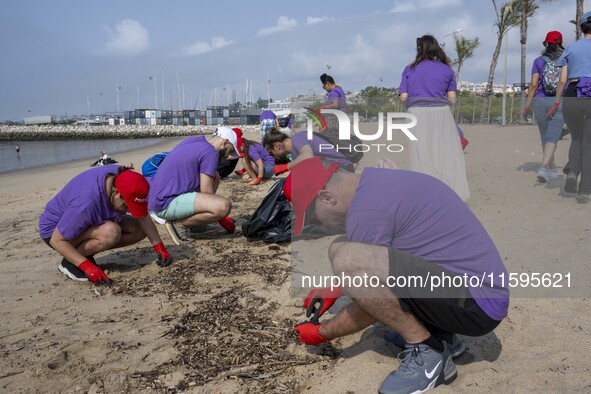 Several volunteers collect waste and garbage during a beach cleanup day in the municipality of Alges in Lisbon, Portugal, on September 21, 2...