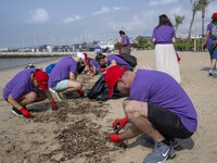 Several volunteers collect waste and garbage during a beach cleanup day in the municipality of Alges in Lisbon, Portugal, on September 21, 2...