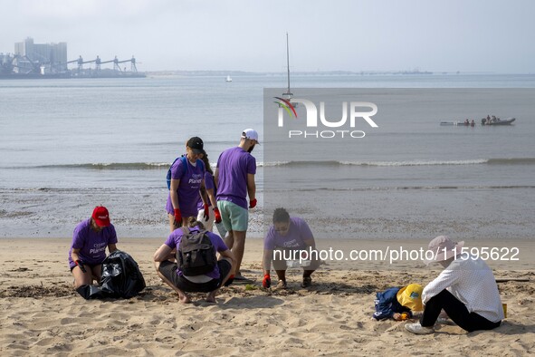 Several volunteers collect waste and garbage during a beach cleanup day in the municipality of Alges in Lisbon, Portugal, on September 21, 2...