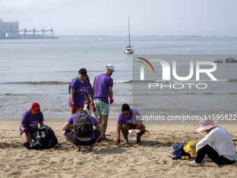 Several volunteers collect waste and garbage during a beach cleanup day in the municipality of Alges in Lisbon, Portugal, on September 21, 2...