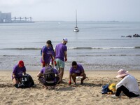 Several volunteers collect waste and garbage during a beach cleanup day in the municipality of Alges in Lisbon, Portugal, on September 21, 2...