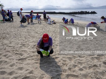 Several volunteers collect waste and garbage during a beach cleanup day in the municipality of Alges in Lisbon, Portugal, on September 21, 2...