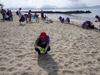 Several volunteers collect waste and garbage during a beach cleanup day in the municipality of Alges in Lisbon, Portugal, on September 21, 2...