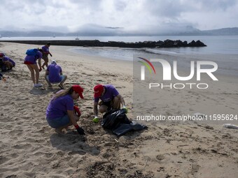 Several volunteers collect waste and garbage during a beach cleanup day in the municipality of Alges in Lisbon, Portugal, on September 21, 2...