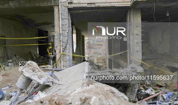 Rescuers sift through the rubble at the scene of an Israeli strike that targets Beirut's southern suburbs, as search and rescue operations c...