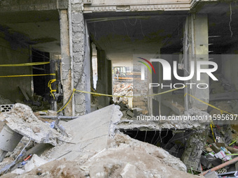 Rescuers sift through the rubble at the scene of an Israeli strike that targets Beirut's southern suburbs, as search and rescue operations c...