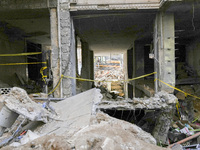 Rescuers sift through the rubble at the scene of an Israeli strike that targets Beirut's southern suburbs, as search and rescue operations c...