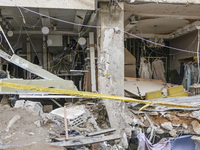 Rescuers sift through the rubble at the scene of an Israeli strike that targets Beirut's southern suburbs, as search and rescue operations c...