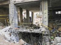 Rescuers sift through the rubble at the scene of an Israeli strike that targets Beirut's southern suburbs, as search and rescue operations c...