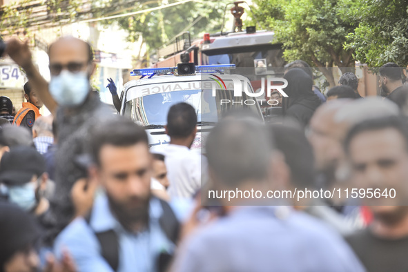 Rescuers sift through the rubble at the scene of an Israeli strike that targets Beirut's southern suburbs, as search and rescue operations c...