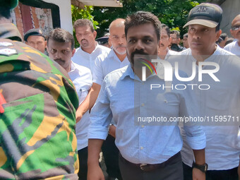 Sri Lanka's presidential candidate of National People's Power (NPP), Anura Kumara Dissanayake, leaves after casting his vote at a polling ce...