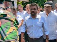 Sri Lanka's presidential candidate of National People's Power (NPP), Anura Kumara Dissanayake, leaves after casting his vote at a polling ce...