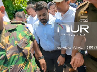 Sri Lanka's presidential candidate of National People's Power (NPP), Anura Kumara Dissanayake, leaves after casting his vote at a polling ce...