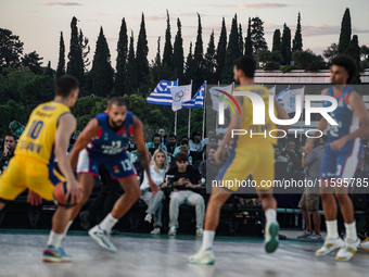 The flags of Greece and the Olympic Games are displayed during the match between Maccabi Playtika Tel Aviv and Anadolu Efes for the Pavlos G...