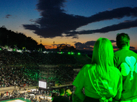 A couple watches the Pavlos Giannakopoulos basketball tournament while embracing each other in Athens, Greece, on September 21, 2024. (