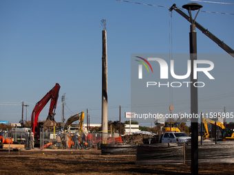 Workers repair a damaged liquefied gas pipeline following an explosion earlier in the week in La Porte, near Houston, Texas, on September 21...