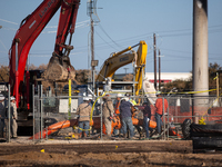 Workers repair a damaged liquefied gas pipeline following an explosion earlier in the week in La Porte, near Houston, Texas, on September 21...