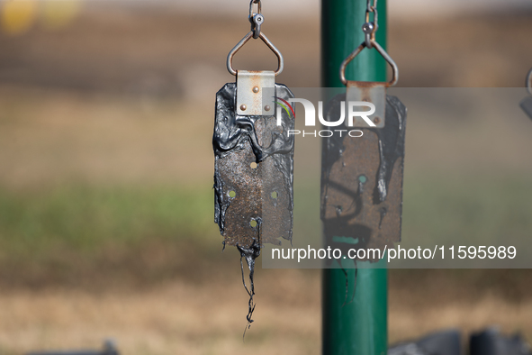 A playground swing melts from the intense heat of a liquefied gas pipeline explosion in a residential area of La Porte near Houston, Texas,...