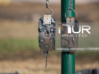 A playground swing melts from the intense heat of a liquefied gas pipeline explosion in a residential area of La Porte near Houston, Texas,...