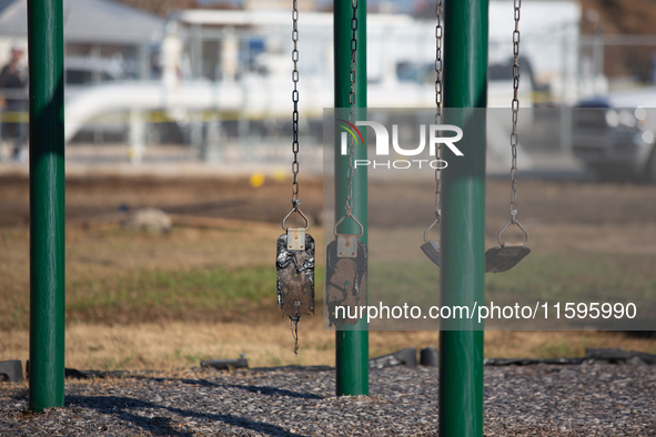 A playground swing melts from the intense heat of a liquefied gas pipeline explosion in a residential area of La Porte near Houston, Texas,...