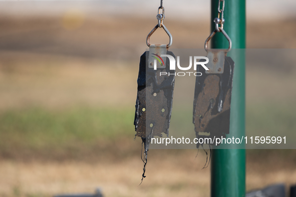 A playground swing melts from the intense heat of a liquefied gas pipeline explosion in a residential area of La Porte near Houston, Texas,...