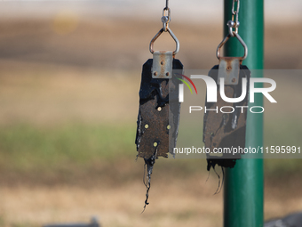 A playground swing melts from the intense heat of a liquefied gas pipeline explosion in a residential area of La Porte near Houston, Texas,...