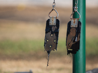 A playground swing melts from the intense heat of a liquefied gas pipeline explosion in a residential area of La Porte near Houston, Texas,...