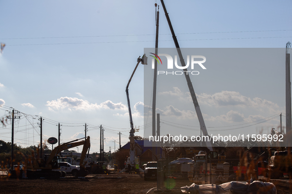 Workers repair a damaged liquefied gas pipeline following an explosion earlier in the week in La Porte, near Houston, Texas, on September 21...