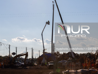 Workers repair a damaged liquefied gas pipeline following an explosion earlier in the week in La Porte, near Houston, Texas, on September 21...