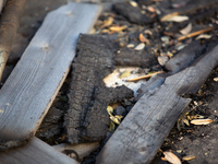 Burnt debris surrounds the site of the explosion in City, Country, on September 21, 2024. (