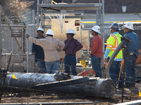 Near the site of the explosion in La Porte near Houston, Texas, on September 21, 2024, workers convene under what appears to be the melted i...