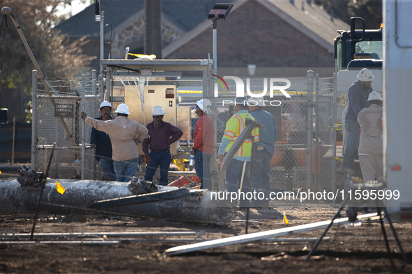 Near the site of the explosion in La Porte near Houston, Texas, on September 21, 2024, workers convene under what appears to be the melted i...