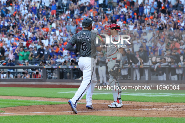 New York Mets' Starling Marte #6 scores during the seventh inning of the baseball game against the Philadelphia Phillies at Citi Field in Co...