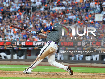 Pete Alonso #20 of the New York Mets singles to drive in a run during the eighth inning of the baseball game against the Philadelphia Philli...