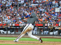 Pete Alonso #20 of the New York Mets singles to drive in a run during the eighth inning of the baseball game against the Philadelphia Philli...