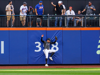 New York Mets left fielder Brandon Nimmo #9 makes a catch and crashes into the wall during the seventh inning of the baseball game against t...