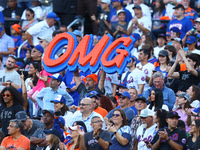 New York Mets fans hold up signs during the eighth inning of a baseball game between the Philadelphia Phillies and New York Mets at Citi Fie...