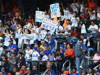 New York Mets fans hold up signs during the eighth inning of a baseball game between the Philadelphia Phillies and New York Mets at Citi Fie...