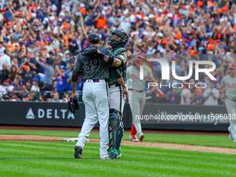 New York Mets relief pitcher Edwin Diaz #39 and catcher Francisco Alvarez #4 celebrate the Mets' 6-2 win in the baseball game against the Ph...