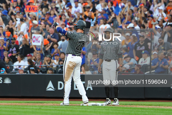 Pete Alonso #20 of the New York Mets celebrates after his RBI single during the eighth inning of the baseball game against the Philadelphia...