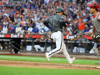 Jose Iglesias #11 of the New York Mets scores during the eighth inning of the baseball game against the Philadelphia Phillies at Citi Field...