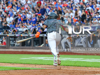 Francisco Alvarez #4 of the New York Mets doubles to drive in two runs during the seventh inning of the baseball game against the Philadelph...