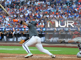 Francisco Alvarez #4 of the New York Mets doubles to drive in two runs during the seventh inning of the baseball game against the Philadelph...