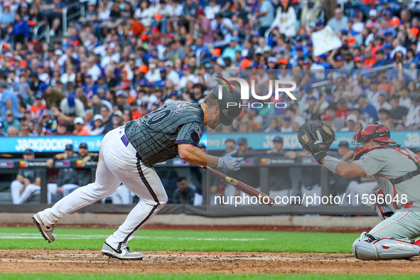 Pete Alonso #20 of the New York Mets is hit by a pitch during the seventh inning of the baseball game against the Philadelphia Phillies at C...